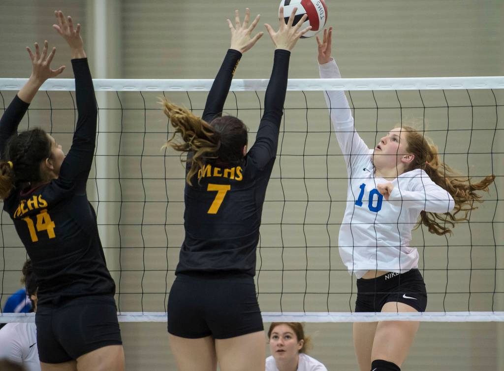 Thunder Mountains Audrey Welling, right, places the ball over Mount Edgecumbes Leticia Skaflestad, center, and Haley Sweet-Cushing during the JIVE Tournament at Juneau-Douglas High School on Friday, Oct. 12, 2018. (Michael Penn | Juneau Empire)