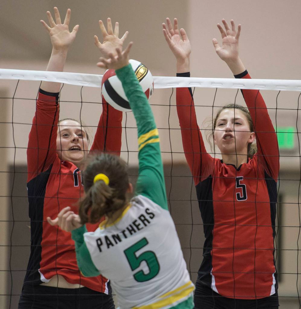 Juneau-Douglas JoJo Griggs, left, and Shaylin Cesar, right, look to block a shot by Craigs Ashley Hansen during the JIVE Tournament at Juneau-Douglas High School on Friday, Oct. 12, 2018, (Michael Penn | Juneau Empire)