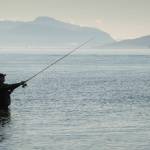Robert Kent enjoys his day off fishing for returning silver salmon in Gastineau Channel on Monday, Sept. 3, 2018. (Michael Penn | Juneau Empire File)