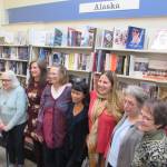 Alaska Women Speak President Carmen Davis stands with writers Mary Lou Spartz, Katie Bausler, Kate Boesser, Miriam Wagoner, Amy Pinney, Margo Waring and Dianne DeSloover at a poetry and prose reading at Hearthside Books in Nugget Mall. (Ben Hohenstatt | Capital City Weekly)
