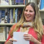 Amy Pinney smiles after reading her poems during an Alaska Women Speak event. (Ben Hohenstatt | Capital City Weekly)