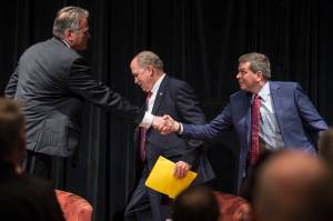 Former state Senate Mike Dunleavy, left, Gov. Bill Walker, center, and former U.S. Senator Mark Begich shake hands after a debate at a Juneau Chamber of Commerce luncheon at Centennial Hall on Thursday, Sept. 6, 2018. (Michael Penn | Juneau Empire)