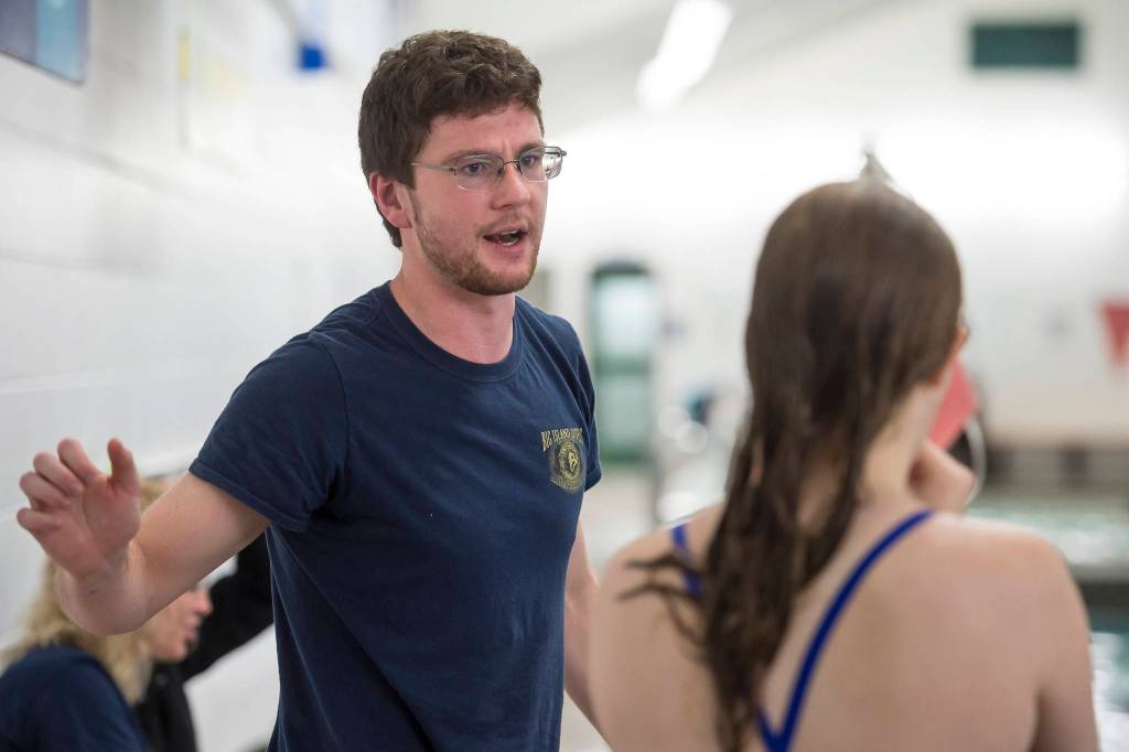 Diving coach Nathan Teal helps Thunder Mountain High School senior Amber Kahklen during practice at the Augustus Brown Swimming Pool on Wednesday, Oct. 17, 2018. (Michael Penn | Juneau Empire)