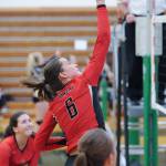 Juneau-Douglas junior middle blocker Addie Prussing taps a return against Kenai as sophomore outside hitter Jenae Pusich looks on during the the Dimond-Service Tournament at Service High School in Anchorage on Friday. JDHS lost 25-19 and 25-22. (Michael Dinneen | For the Juneau Empire)