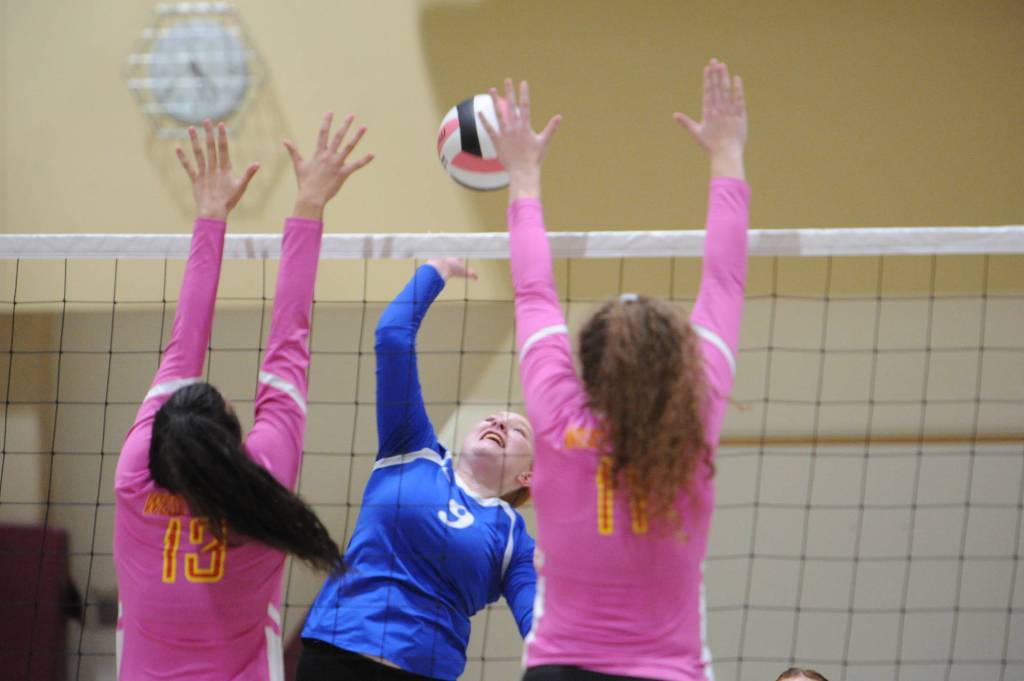 Thunder Mountains Lexi Murray leaps for a return between West Valleys Ellen Silva and Jozey Martallarro. Thunder Mountain won 25-22 and 25-21. (Michael Dinneen | For the Juneau Empire)