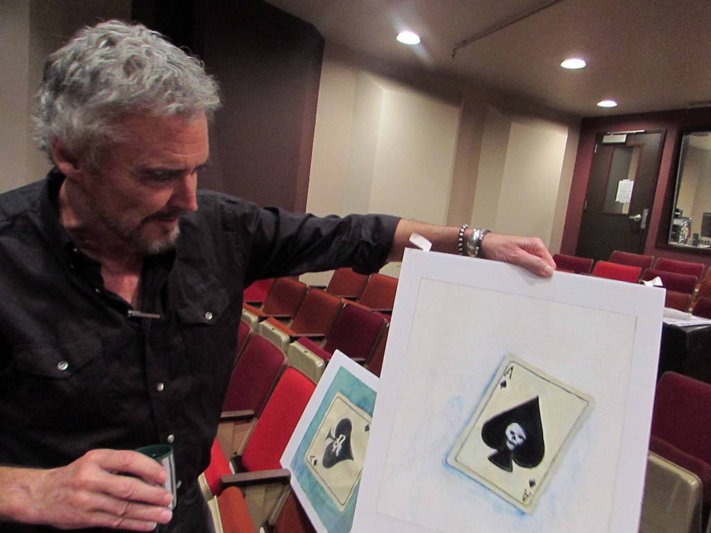 Dave Hunsaker, librettist and stage director for The Princess Sophia opera, shows off art by Dan Fruits, which will be projected at a much larger scale during the opera. Ben Hohenstatt | Capital City Weekly)