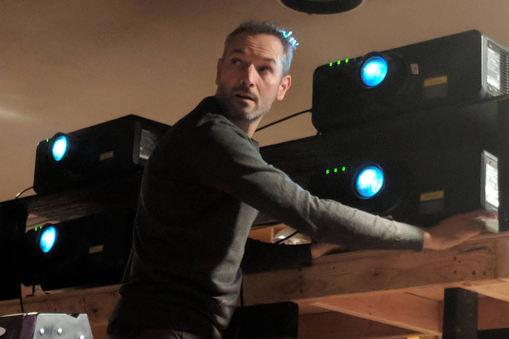 Greg Mitchell, projection designer, calibrates large projectors shipped from Seattle, which will be used during The Princess Sophia opera. (Ben Hohenstatt | Capital City Weekly)