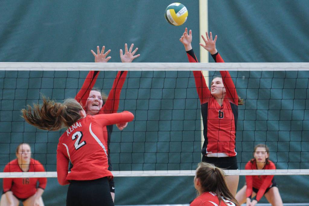 From left, Juneau-Douglas Gabi Griggs and Addie Prussing block a shot by Kenais Bethany Morris. The Crimson Bears lost to the Kardinals 25-19 and 25-22. (Michael Dinneen | For the Juneau Empire)