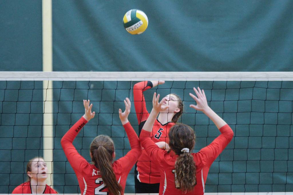 JDHS JoJo Griggs attempts to blast a return by Kenais Bethany Morris and Jenna Strieff. The Crimson Bears lost to the Kardinals 25-19 and 25-22. (Michael Dinneen | For the Juneau Empire)
