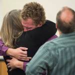 Ty Grussendorf, 24, center, hugs his parents after pleading guilty to two counts of sexual abuse of a minor in Juneau Superior Court on Monday, Oct. 22, 2018. (Michael Penn | Juneau Empire)