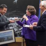 Outgoing Mayor Ken Koelsch, right, and Municipal Clerk Beth McEwen, thanks Assembly member Norton Gregory for his service in the Assembly chambers on Monday, Oct. 15, 2018. (Michael Penn | Juneau Empire)