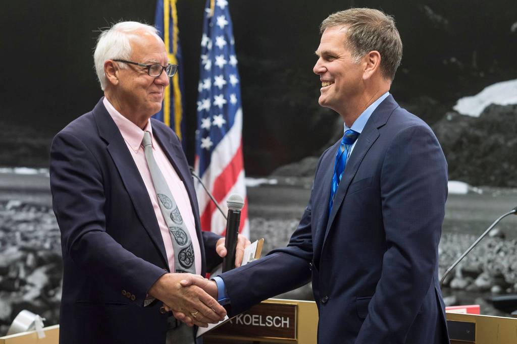 Outgoing Mayor Ken Koelsch, left, thanks Assembly member Jerry Nankervis for his service in the Assembly chambers on Monday, Oct. 15, 2018. (Michael Penn | Juneau Empire)