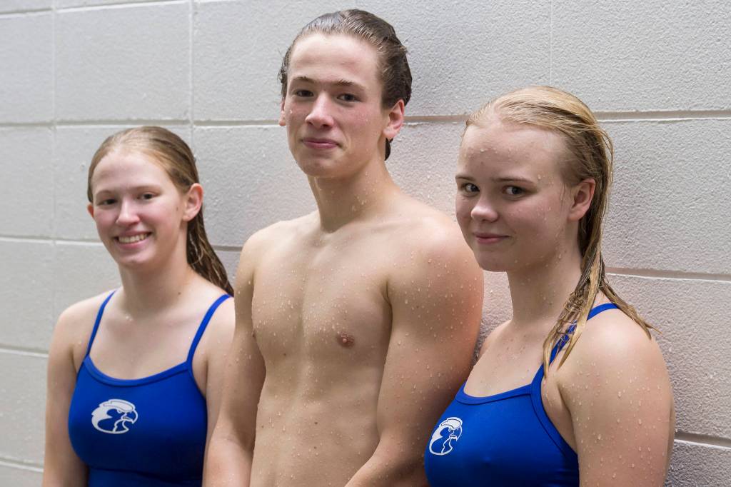 Thunder Mountain High School senior Amber Kahklen, left, Juneau-Douglas High School senior Cian Hart, center, and TMHS senior Rosemary Kiessling pose for a picture at the Augustus Brown Swimming Pool on Wednesday, Oct. 17, 2018. (Michael Penn | Juneau Empire)
