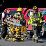 Capital City Fire/Rescue personnel wheel a man to a waiting ambulance at the scene of a two-car accident near the Egan Drive and Mendenhall Loop Road intersection in the Mendenhall Valley in March 2016. Two people were treated at Bartlett Regional Hospital for minor injuries. (Michael Penn | Juneau Empire File)