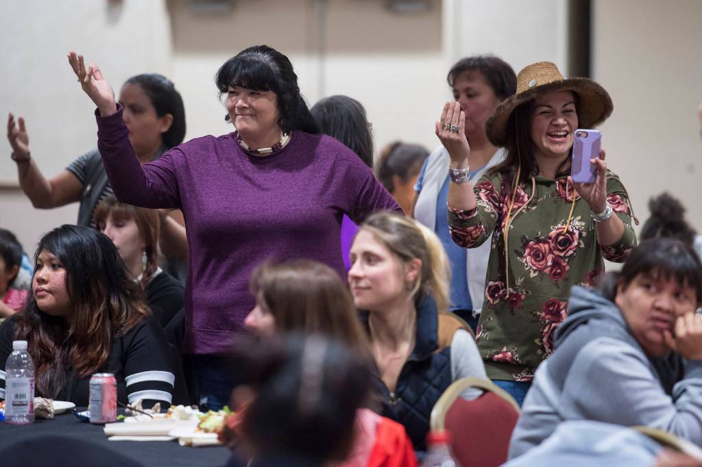 People pay tribute to the Woosh.ji.een Dance Group as they perform during a Celebrate Survivors gathering sponsored by Central Council Tlingit and Haida Indian Tribes of Alaska and AWARE in the Elizabeth Peratrovich Hall on Tuesday, Oct. 23, 2018. October is Domestic Violence Awareness Month. (Michael Penn | Juneau Empire)