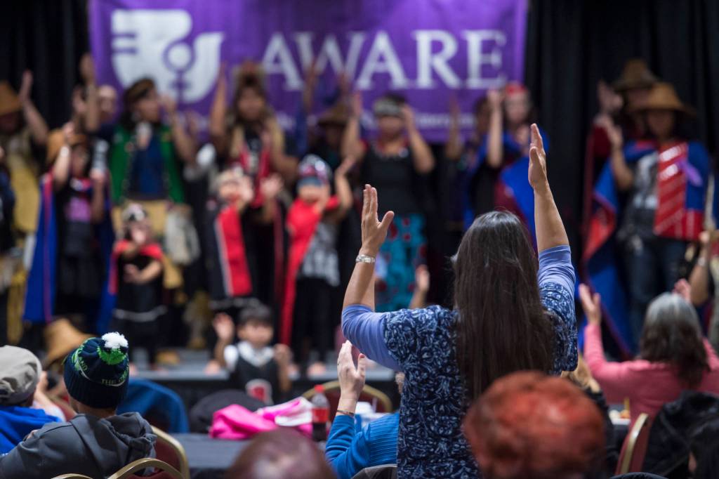 People pay tribute to the Woosh.ji.een Dance Group as they perform during a Celebrate Survivors gathering sponsored by Central Council Tlingit and Haida Indian Tribes of Alaska and AWARE in the Elizabeth Peratrovich Hall on Tuesday, Oct. 23, 2018. October is Domestic Violence Awareness Month. (Michael Penn | Juneau Empire)