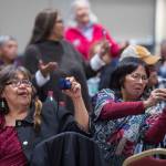 People pay tribute to the Woosh.ji.een Dance Group as they perform during a Celebrate Survivors gathering sponsored by Central Council Tlingit and Haida Indian Tribes of Alaska and AWARE in the Elizabeth Peratrovich Hall on Tuesday, Oct. 23, 2018. October is Domestic Violence Awareness Month. (Michael Penn | Juneau Empire)