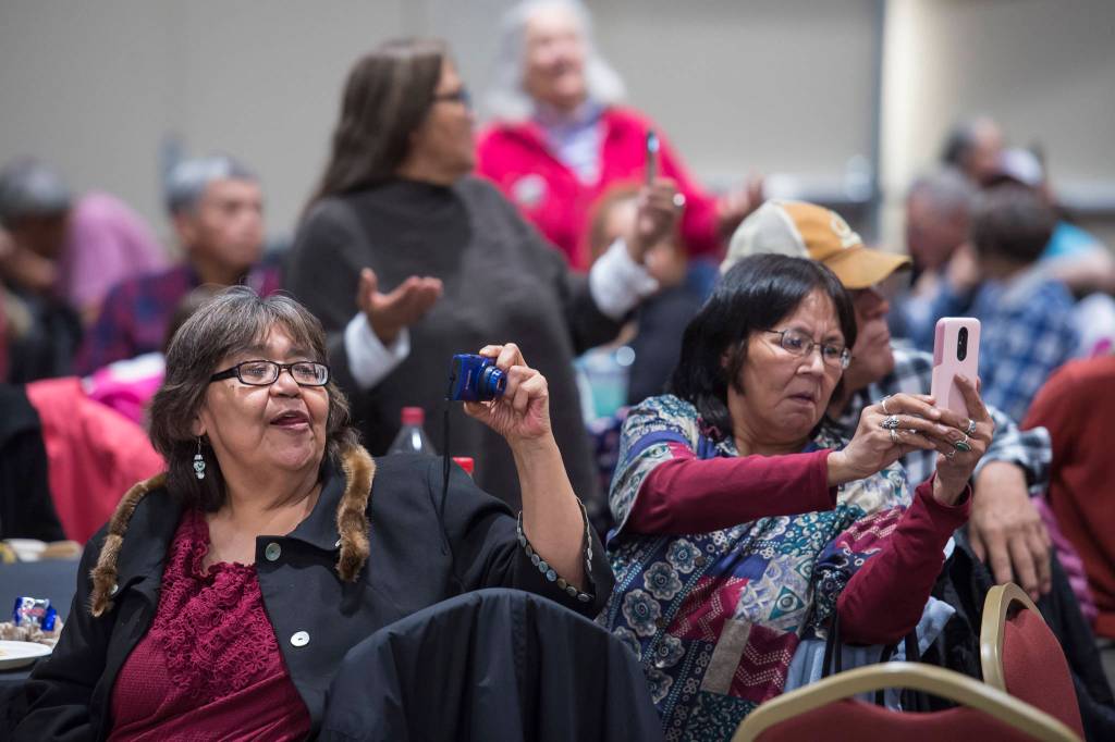 People pay tribute to the Woosh.ji.een Dance Group as they perform during a Celebrate Survivors gathering sponsored by Central Council Tlingit and Haida Indian Tribes of Alaska and AWARE in the Elizabeth Peratrovich Hall on Tuesday, Oct. 23, 2018. October is Domestic Violence Awareness Month. (Michael Penn | Juneau Empire)