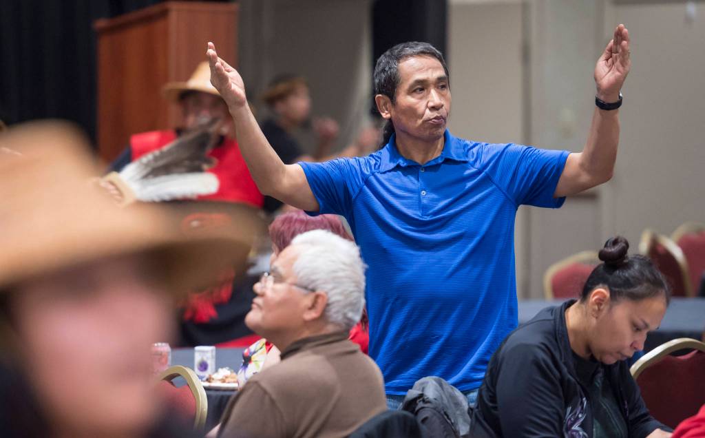 People pay tribute to the Woosh.ji.een Dance Group as they perform during a Celebrate Survivors gathering sponsored by Central Council Tlingit and Haida Indian Tribes of Alaska and AWARE in the Elizabeth Peratrovich Hall on Tuesday, Oct. 23, 2018. October is Domestic Violence Awareness Month. (Michael Penn | Juneau Empire)