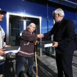 George Edwardson, board member for Inuit Circumpolar Council-Alaska and President of the Inupiat Community of the Arctic Slope (ICAS) hands the first of three binders holding over 104,000 signatures on an international petition calling for Carnival Corporation to end its use of heavy fuel oil in the Arctic and Subarctic to Tom Strang, Senior Vice President of Maritime Affairs for cruise industry giant. In July this year, the Inuit Circumpolar Council issued a formal Declaration calling for a phaseout of heavy fuel oil in the region. (Courtesy Photo | Jiri Rezac via Stand.earth)
