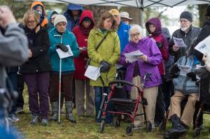 Mary Lou Spartz reads the names of victims buried at the Evergreen Cemetery during a memorial service on Thursday, Oct. 25, 2018, on the 100th anniversary of the sinking of the Princess Sophia. The service takes place at the gravesite of Walter Harper and his wife, Frances Wells. (Michael Penn | Juneau Empire)