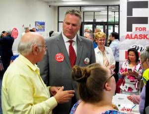 FILE - In this Aug. 19, 2018 file photo, Republican gubernatorial candidate Mike Dunleavy, second from left, stands near his campaign table at a meet-and-greet event in the lobby of Anchorage Baptist Temple in Anchorage, Alaska. As a kid growing up on the East Coast, Mike Dunleavy dreamed of coming to Alaska, of hunting caribou, fishing in wild streams and losing himself in the states vast, open spaces. Now, after nearly 35 years in his adopted state, the conservative Republican is vying to become Alaskas next governor. (AP Photo/Becky Bohrer, File)                                In this Aug. 19 file photo, Republican gubernatorial candidate Mike Dunleavy, second from left, stands near his campaign table at a meet-and-greet event in the lobby of Anchorage Baptist Temple in Anchorage. (Becky Bohrer | The Associated Press File)