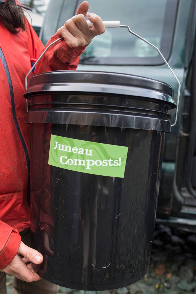 Lisa Daugherty, owner of Juneau Composts!, holds one of her residential buckets to hold food scraps on Wednesday, Oct. 24, 2018. Daugherty currently picks up compost from 140 homes. (Michael Penn | Juneau Empire)