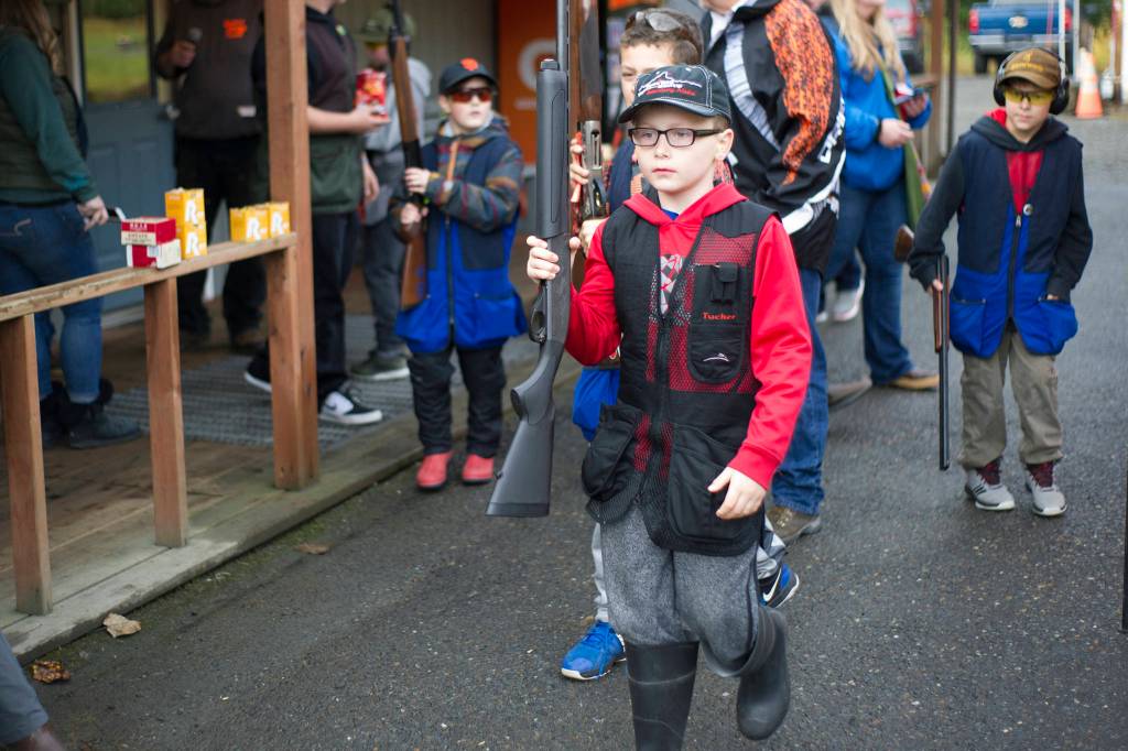 Tucker Gibson, 8, of Petersburgs Devils Club Shooters, walks out of the Juneau Gun Club toward the range during the fourth annual Southeast Fall Shoot Tournament on Saturday. The Devils Club Shooters brought eight youth to the two-day event. (Nolin Ainsworth | Juneau Empire)