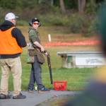 Juneau Trap Teams Jager Hunt, 13, looks back at tournament official Carl Ramseth while competing in single trap at the fourth annual Southeast Fall Shoot Tournament on Saturday at the Juneau Gun Club. (Nolin Ainsworth | Juneau Empire)