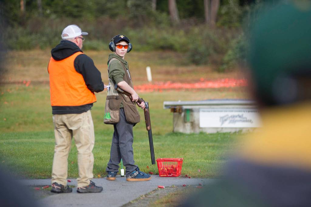 Juneau Trap Teams Jager Hunt, 13, looks back at tournament official Carl Ramseth while competing in single trap at the fourth annual Southeast Fall Shoot Tournament on Saturday at the Juneau Gun Club. (Nolin Ainsworth | Juneau Empire)