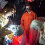 Anthonyu Hotka customizes his mask at the Haunted Station at the U.S. Coast Guards Station Juneau on Friday, Oct. 26, 2018. Station personnel pay for all the decoration themselves and take three weeks to ready the station. Entry is non perishable food items for the Southeast Alaska Food Bank. (Michael Penn | Juneau Empire)