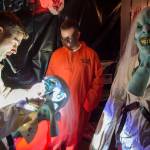 Anthonyu Hotka customizes his mask at the Haunted Station at the U.S. Coast Guards Station Juneau on Friday, Oct. 26, 2018. Station personnel pay for all the decoration themselves and take three weeks to ready the station. Entry is non perishable food items for the Southeast Alaska Food Bank. (Michael Penn | Juneau Empire)