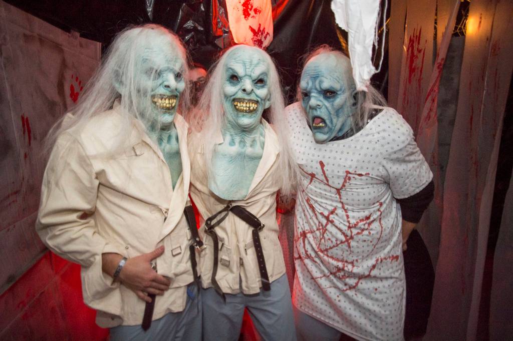 Juneau residents react to scares and chills as they make their way through the Haunted Station at the U.S. Coast Guards Station Juneau on Friday, Oct. 26, 2018. Station personnel pay for all the decoration themselves and take three weeks to ready the station. Entry is non perishable food items for the Southeast Alaska Food Bank. (Michael Penn | Juneau Empire)