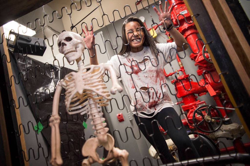 Lindzy Nguyen does her part to scare Juneau residents visiting the Haunted Station at the U.S. Coast Guards Station Juneau on Friday, Oct. 26, 2018. Station personnel pay for all the decoration themselves and take three weeks to ready the station. Entry is non perishable food items for the Southeast Alaska Food Bank. (Michael Penn | Juneau Empire)