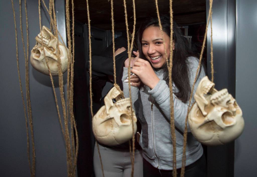 Juneau residents react to scares and chills as they make their way through the Haunted Station at the U.S. Coast Guards Station Juneau on Friday, Oct. 26, 2018. Station personnel pay for all the decoration themselves and take three weeks to ready the station. Entry is non perishable food items for the Southeast Alaska Food Bank. (Michael Penn | Juneau Empire)