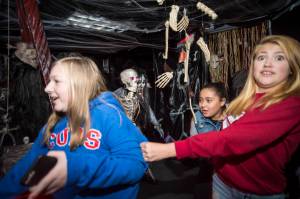Juneau residents react to scares and chills as they make their way through the Haunted Station at the U.S. Coast Guards Station Juneau on Friday, Oct. 26, 2018. Station personnel pay for all the decoration themselves and take three weeks to ready the station. Entry is non perishable food items for the Southeast Alaska Food Bank. (Michael Penn | Juneau Empire)