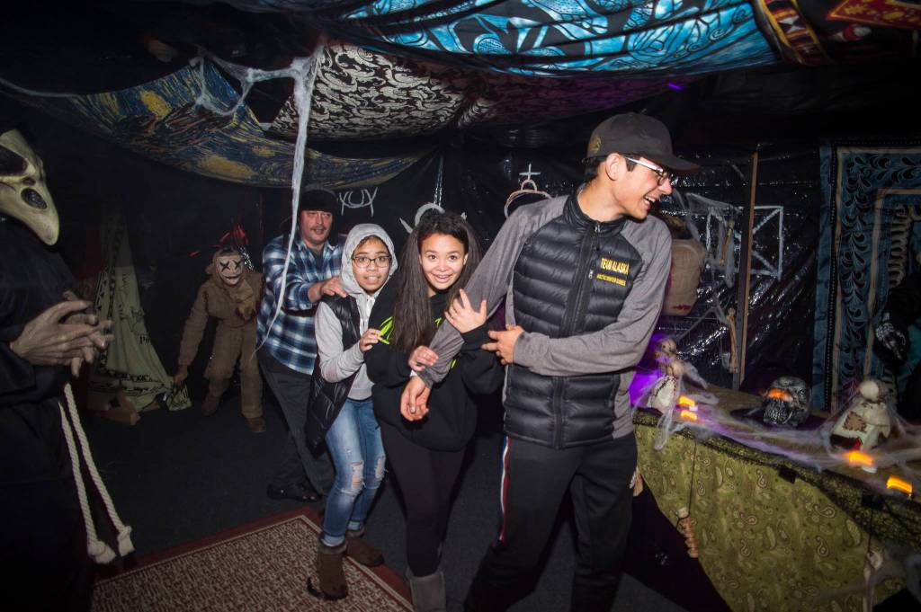 Juneau residents react to scares and chills as they make their way through the Haunted Station at the U.S. Coast Guards Station Juneau on Friday, Oct. 26, 2018. Station personnel pay for all the decoration themselves and take three weeks to ready the station. Entry is non perishable food items for the Southeast Alaska Food Bank. (Michael Penn | Juneau Empire)