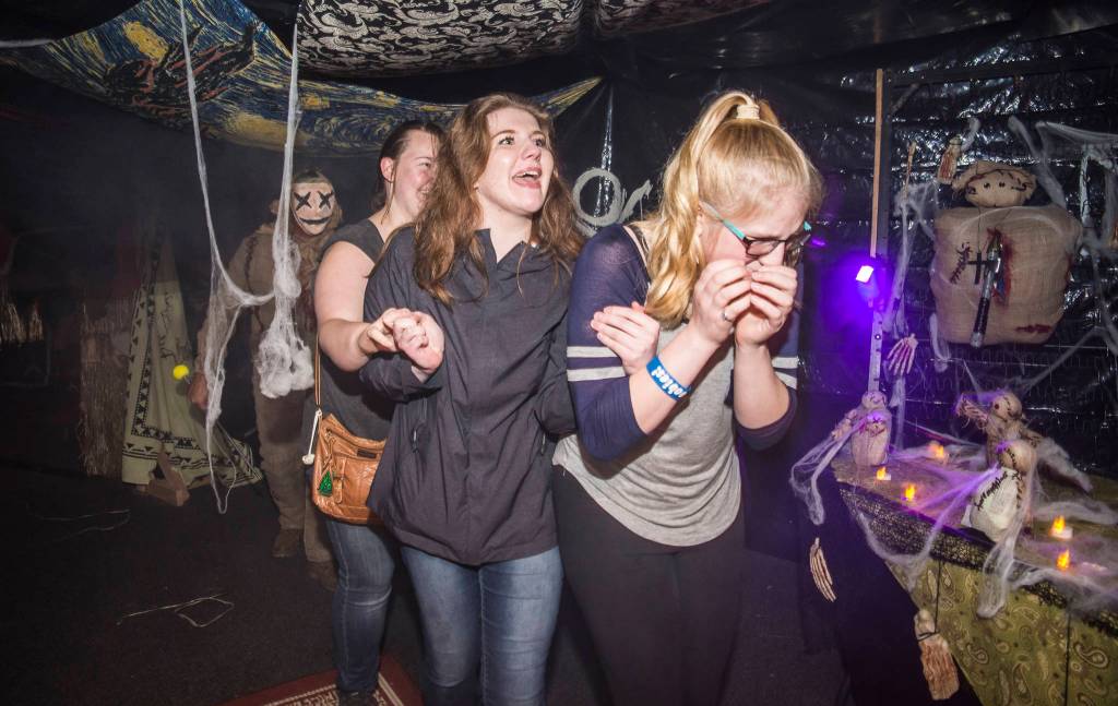 Juneau residents react to scares and chills as they make their way through the Haunted Station at the U.S. Coast Guards Station Juneau on Friday, Oct. 26, 2018. Station personnel pay for all the decoration themselves and take three weeks to ready the station. Entry is non perishable food items for the Southeast Alaska Food Bank. (Michael Penn | Juneau Empire)