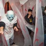 Juneau residents react to scares and chills as they make their way through the Haunted Station at the U.S. Coast Guards Station Juneau on Friday, Oct. 26, 2018. Station personnel pay for all the decoration themselves and take three weeks to ready the station. Entry is non perishable food items for the Southeast Alaska Food Bank. (Michael Penn | Juneau Empire)