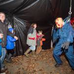 Juneau residents react to scares and chills as they make their way through the Haunted Station at the U.S. Coast Guards Station Juneau on Friday, Oct. 26, 2018. Station personnel pay for all the decoration themselves and take three weeks to ready the station. Entry is non perishable food items for the Southeast Alaska Food Bank. (Michael Penn | Juneau Empire)