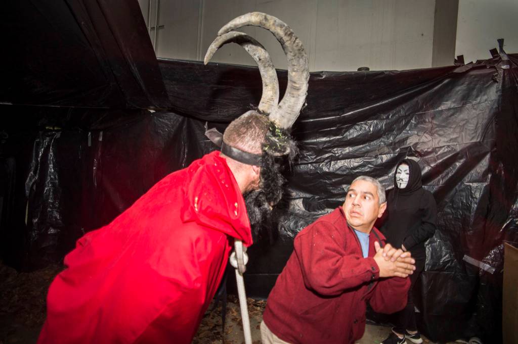 Juneau residents react to scares and chills as they make their way through the Haunted Station at the U.S. Coast Guards Station Juneau on Friday, Oct. 26, 2018. Station personnel pay for all the decoration themselves and take three weeks to ready the station. Entry is non perishable food items for the Southeast Alaska Food Bank. (Michael Penn | Juneau Empire)