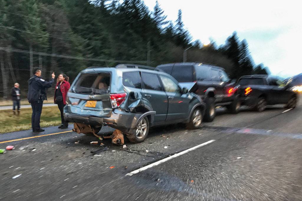 A Juneau Police Department Officer gives a woman driver a sobriety test after a four-vehicle accident on the inbound land of Egan Drive between Glacier Highway and Mendenhall Loop Road on Wednesday, Oct. 24, 2018. (Michael Penn | Juneau Empire)