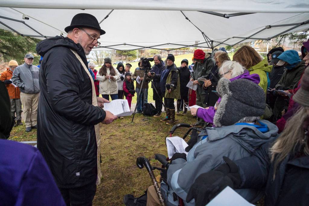 The Reverend Gordon Blue, of The Church of the Holy Trinity, leads a memorial service at the Evergreen Cemetery on Thursday, Oct. 25, 2018, on the 100th anniversary of the sinking of the Princess Sophia. The service takes place at the gravesite of Walter Harper and his wife, Frances Wells. (Michael Penn | Juneau Empire)