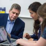 Democrat gubernatorial candidate Mark Begich watches as Thunder Mountain High School senior students Tristan Weissmuller, center, and Briannah Letter work on a candidate voter page during their government class on Friday, Oct. 26, 2018. (Michael Penn | Juneau Empire)