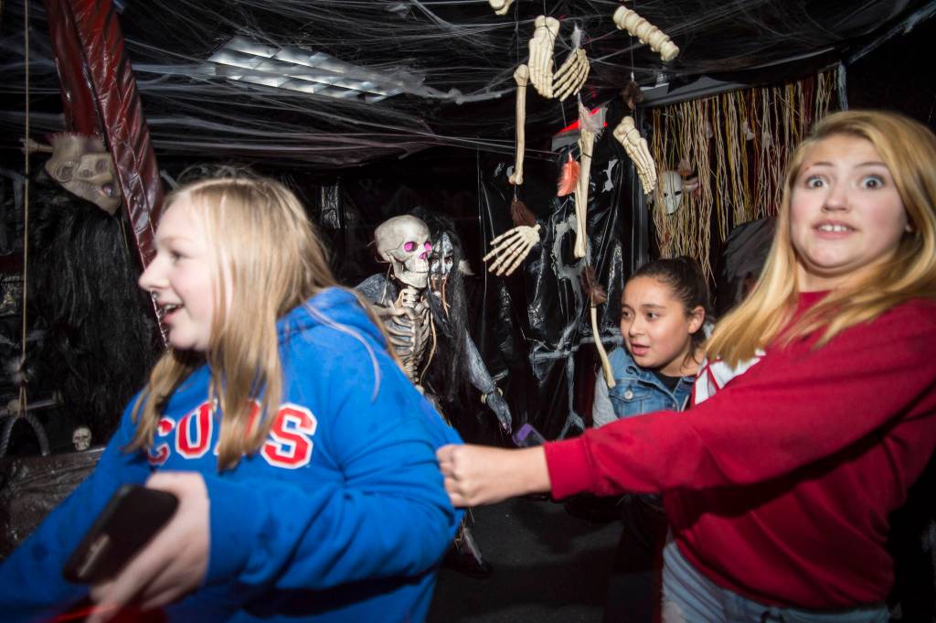 Juneau residents react to scares and chills as they make their way through the Haunted Station at the U.S. Coast Guards Station Juneau on Friday, Oct. 26, 2018. Station personnel pay for all the decoration themselves and take three weeks to ready the station. Entry is non perishable food items for the Southeast Alaska Food Bank. (Michael Penn | Juneau Empire)
