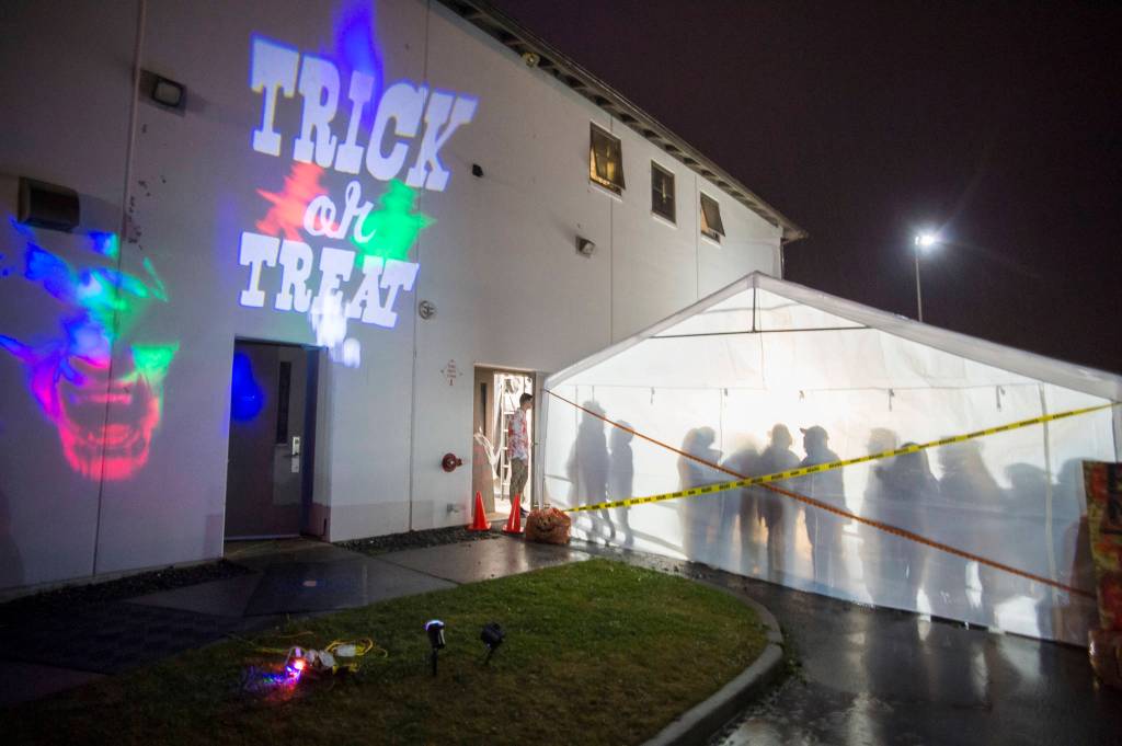 Juneau residents react to scares and chills as they make their way through the Haunted Station at the U.S. Coast Guards Station Juneau on Friday, Oct. 26, 2018. Station personnel pay for all the decoration themselves and take three weeks to ready the station. Entry is non perishable food items for the Southeast Alaska Food Bank. (Michael Penn | Juneau Empire)
