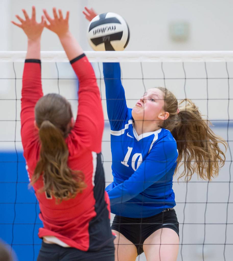 Thunder Mountains Audrey Welling spikes the ball against Juneau-Douglas Shaylin Cesar at TMHS on Friday, Oct. 26, 2018. (Michael Penn | Juneau Empire