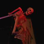 A skeleton watches over the Jones home at the corner of 10th Street and Glacier Avenue on Monday, Oct. 29, 2018. The house becomes the Witchs Haunted House for a few hours every Halloween, welcoming around 400 people into the basement for a scare or several. (Alex McCarthy | Juneau Empire)
