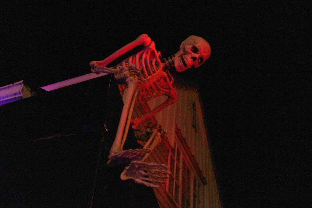 A skeleton watches over the Jones home at the corner of 10th Street and Glacier Avenue on Monday, Oct. 29, 2018. The house becomes the Witchs Haunted House for a few hours every Halloween, welcoming around 400 people into the basement for a scare or several. (Alex McCarthy | Juneau Empire)