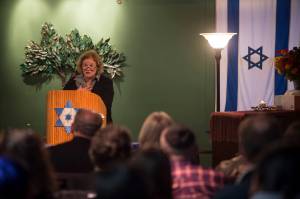 Barbara Sheinberg speaks about growing up in Pittsburghs Squirrel Hill neighborhood a couple blocks away from the Tree of Life synagogue where 11 people were killed by a gunman on Saturday. An overflowing crowd gathered at Temple Sukkat Shalom on Tuesday, Oct. 30, 2018, to honor the memory of the people killed. (Michael Penn | Juneau Empire)